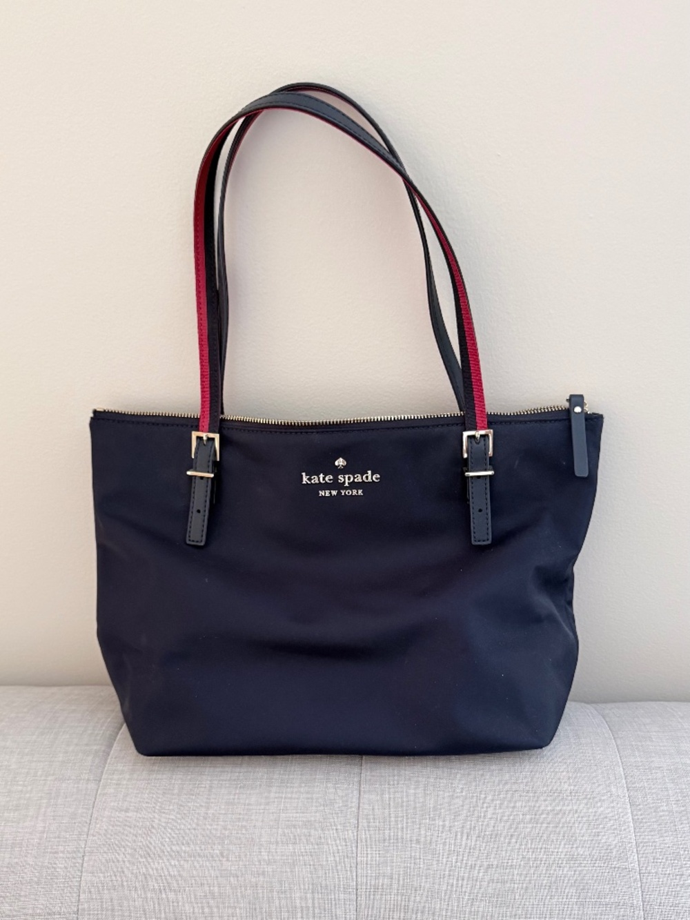 kate spade navy tote with red-trim straps